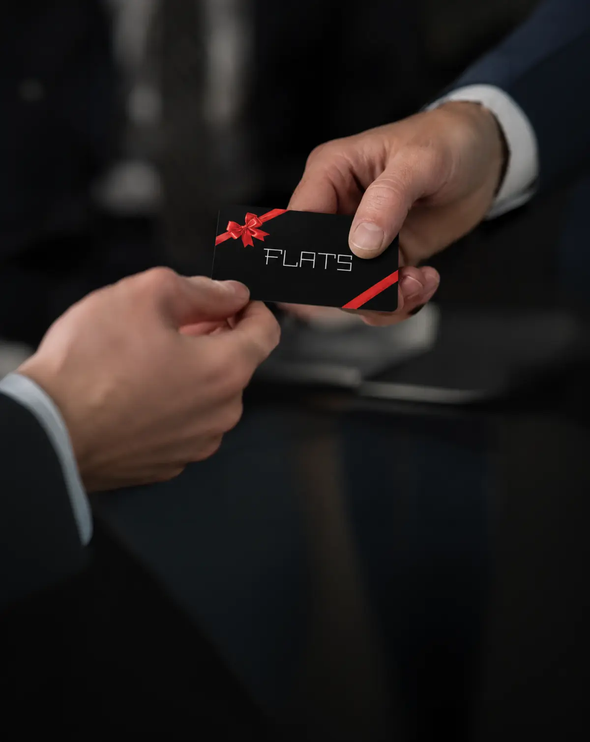 A Flats gift card being presented to a recipient
