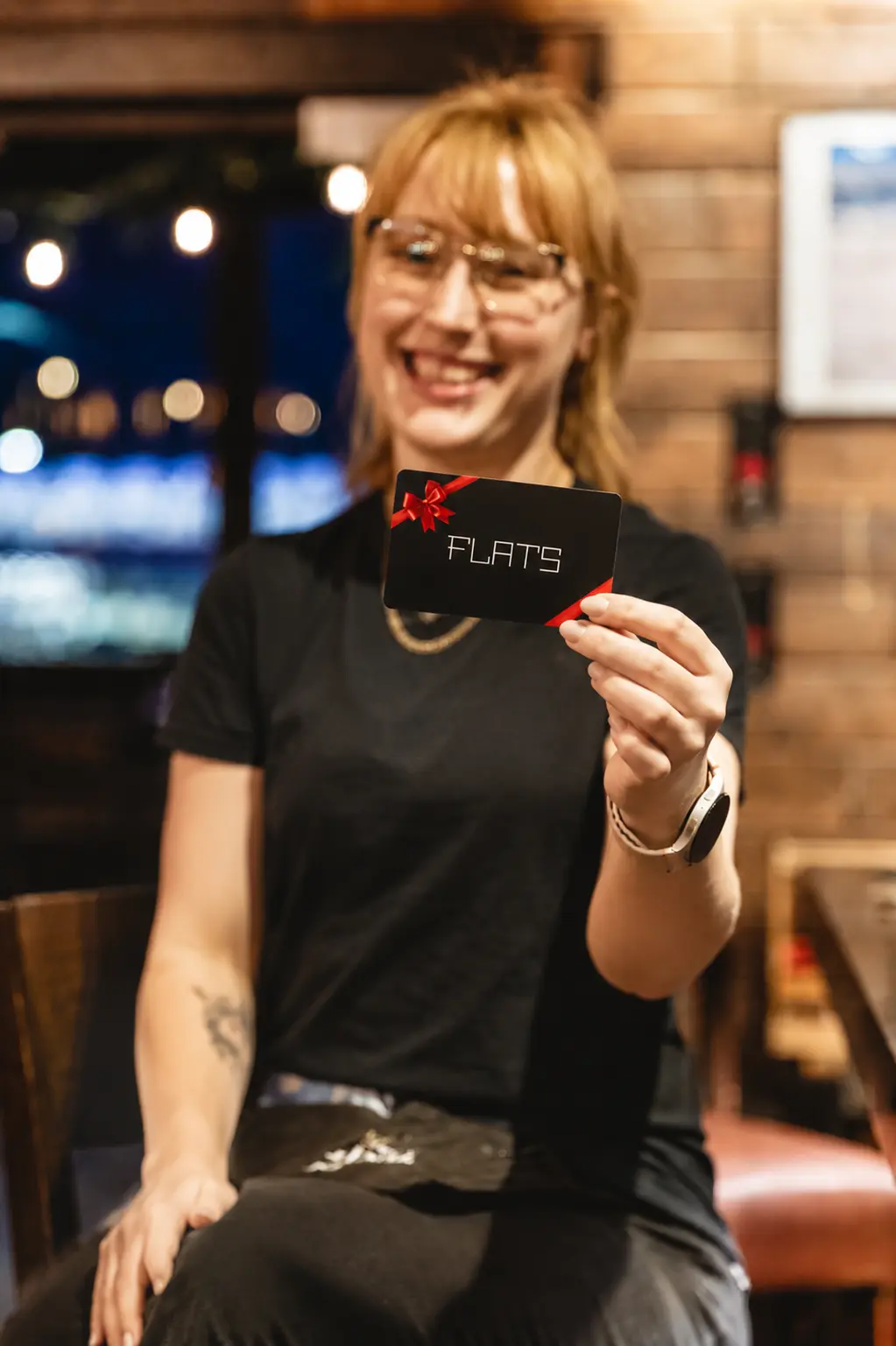 Flats team member presenting a gift card